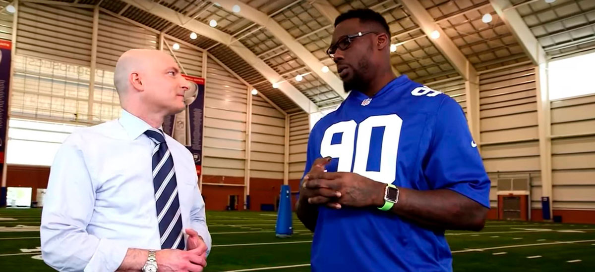 two men talking at football practice